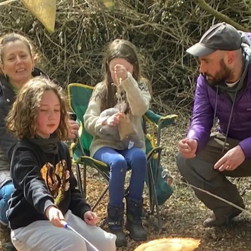 A family enjoying an activity at the forest school